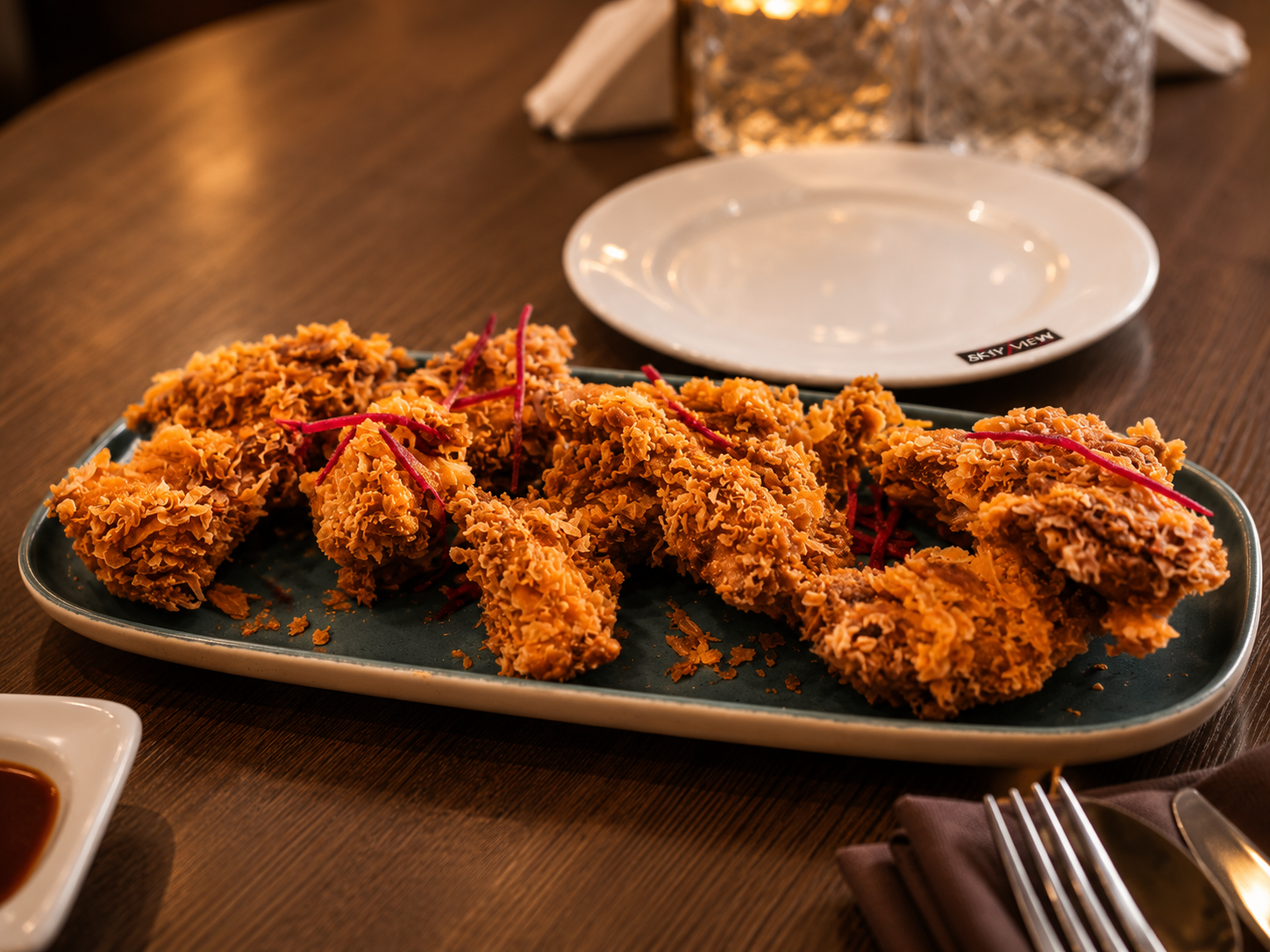 Crispy fried chicken served on a stone plate at Sky View