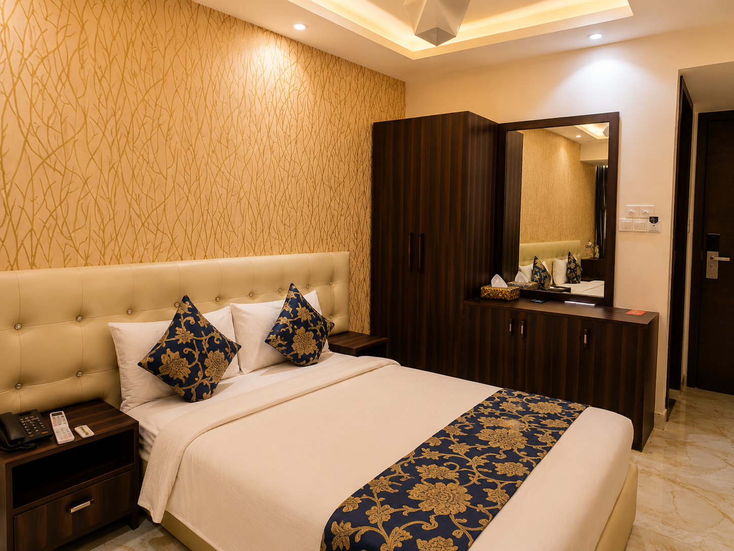 Couple Deluxe room with a double bed, wardrobe and dressing mirror