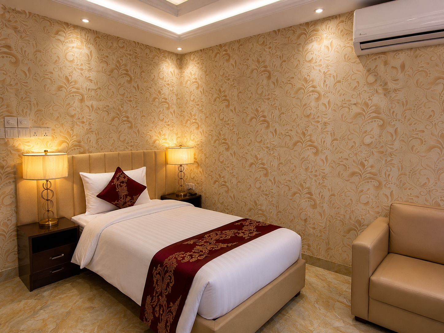 Honeymoon Suite with a king bed, brass lamps and patterned wallpaper